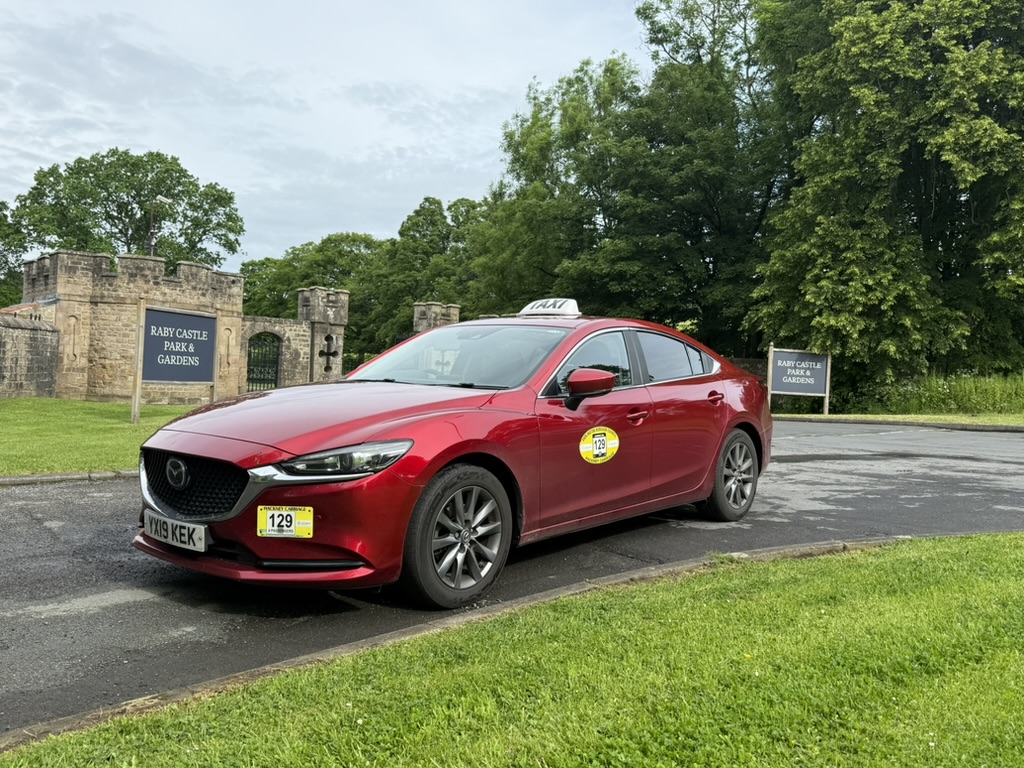 C&P Taxis red saloon ready for a journey near Darlington