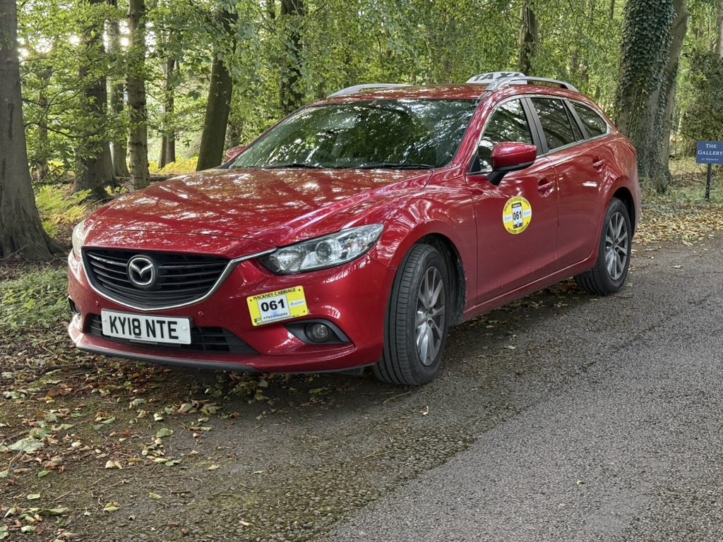 C&P Taxis red estate car ready for a pre-booked journey