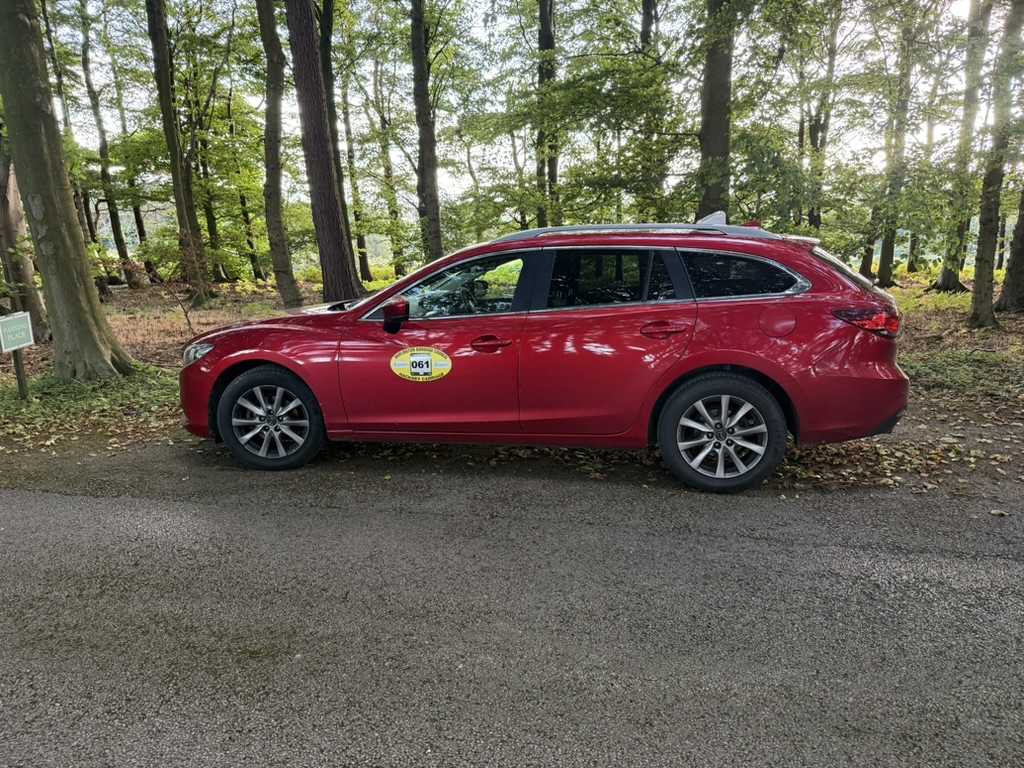 C&P Taxis estate car in a quiet woodland setting